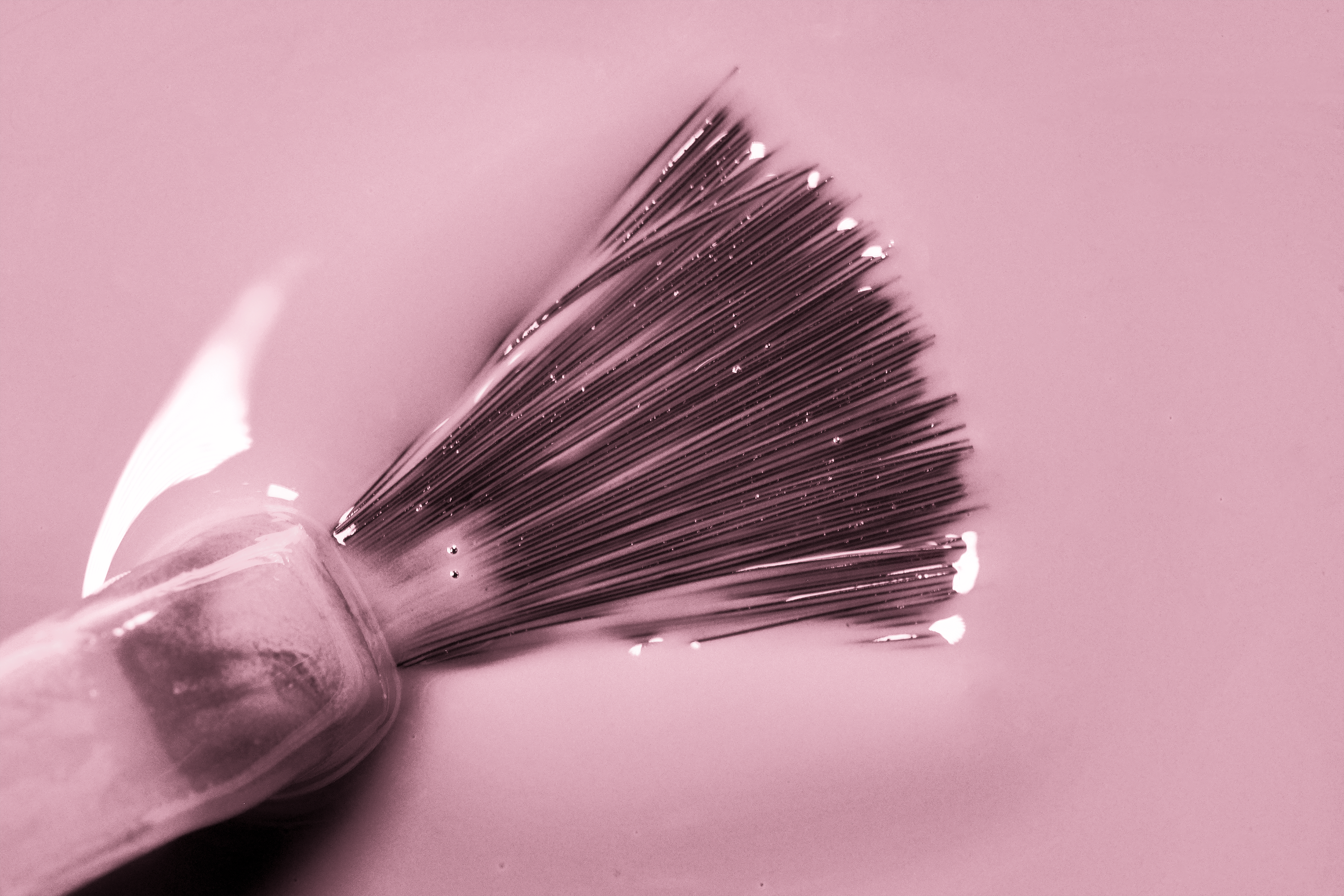 close up image of High quality pink nail Polish with brush